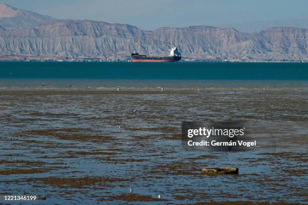 large oil tanker or cargo ship at shahid rajai port from qeshm island in low tide, persian gulf, iran - straits stock pictures, royalty-free photos & images