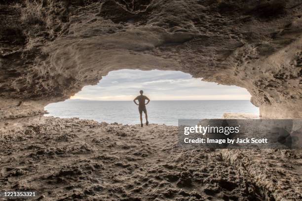 man standing on rock edge - jervis bay stock pictures, royalty-free photos & images