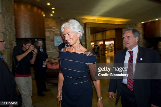 Christine Lagarde, managing director of the International Monetary Fund , center, arrives for an opening dinner during an economic symposium...