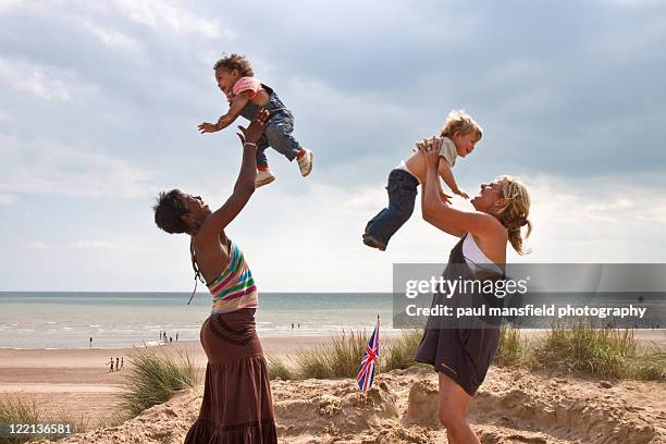 mums bonding with their sons - camber sands ストックフォトと画像