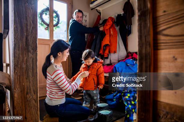 lets keep you warm - family getting dressed stock pictures, royalty-free photos & images