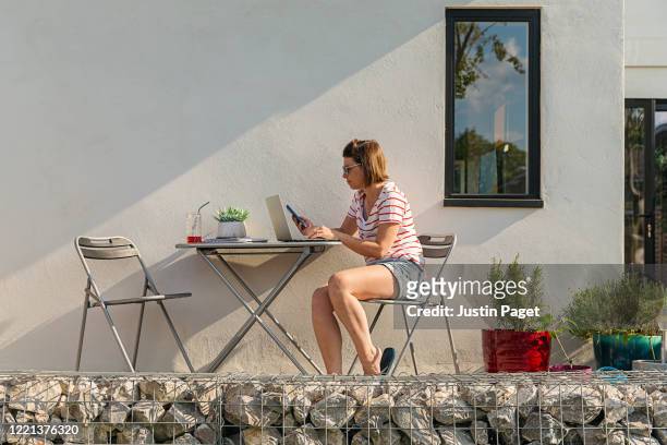 woman working from home garden - stone wall garden stock pictures, royalty-free photos & images
