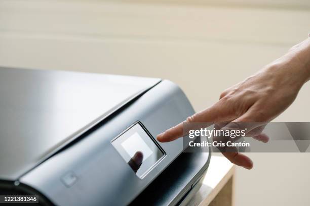 hand using computer printer - printer stock pictures, royalty-free photos & images