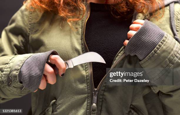 teenage girl holding knife - stabbing ストックフォトと画像