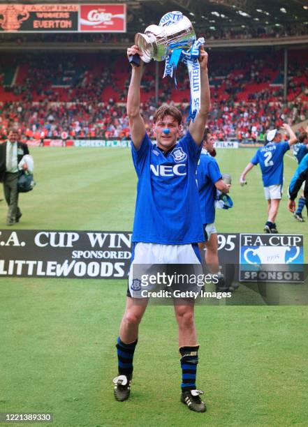 Everton forward Duncan Ferguson wearing a blue nose lifts the trophy to photographers after the 1995 FA Cup Final between Everton and Manchester...