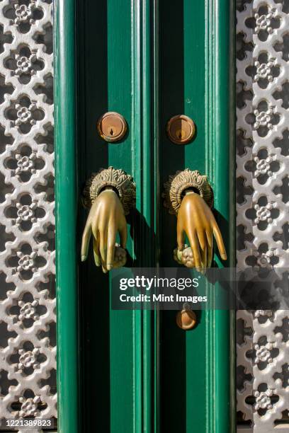 door knockers in the form of hands, algarve, portugal - door knocker stock pictures, royalty-free photos & images