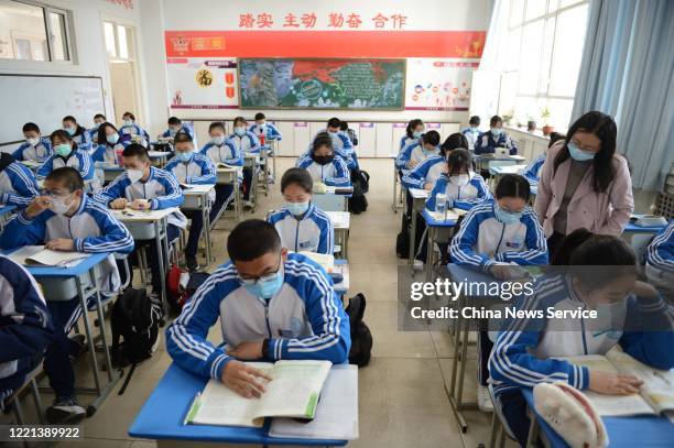 Students wearing face masks have a class at No.One Middle School on April 27, 2020 in Huhhot, Inner Mongolia Autonomous Region of China. Students in...