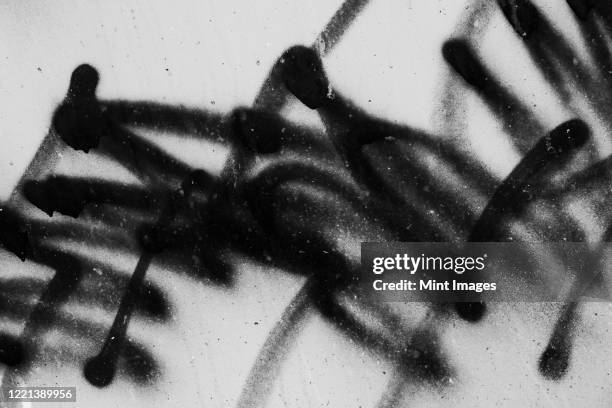 black graffiti paint markings on urban wall, close up - graffiti background bildbanksfoton och bilder