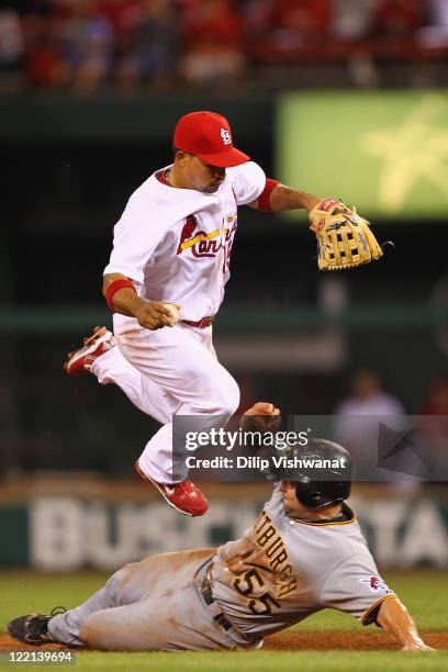 Michael McKenry of the Pittsburgh Pirates breaks up a double play against Rafael Furcal of the St. Louis Cardinals at Busch Stadium on August 25,...