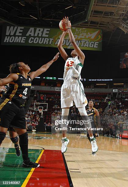 Ashley Robinson of the Seattle Storm shoots against Amber Holt of the Tulsa Shock during the game on August 25, 2011 at Key Arena in Seattle,...