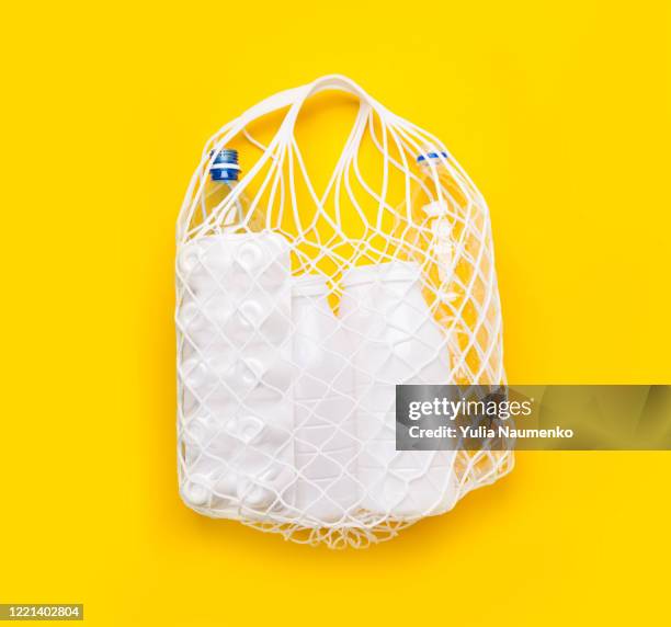 plastic trash in eco friendly mesh bag. ecological concept. sorting and collecting plastic waste. - reusable shopping bag drawing stock-fotos und bilder