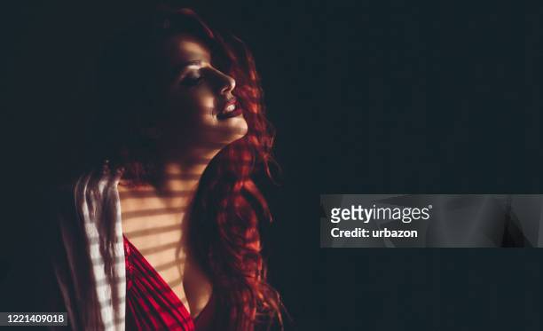 beautiful red hair woman in dark - blinder stock pictures, royalty-free photos & images