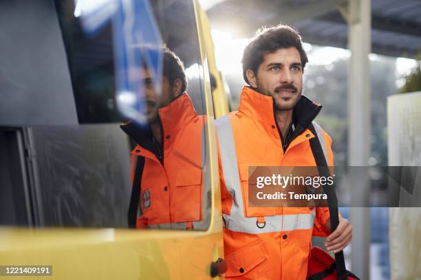 ambulance staff worker exiting the vehicle. - ambulance arrival stock pictures, royalty-free photos & images