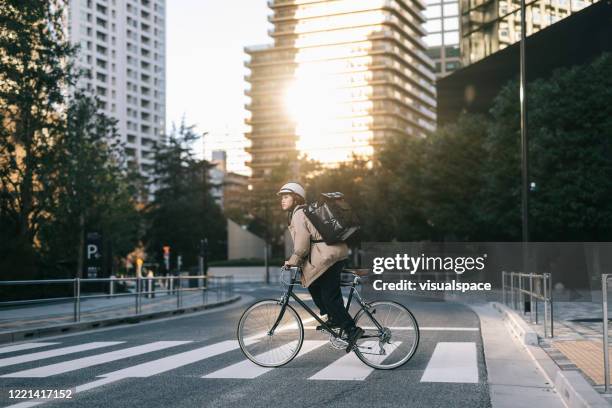 food courier riding in the city - biking to work stock pictures, royalty-free photos & images