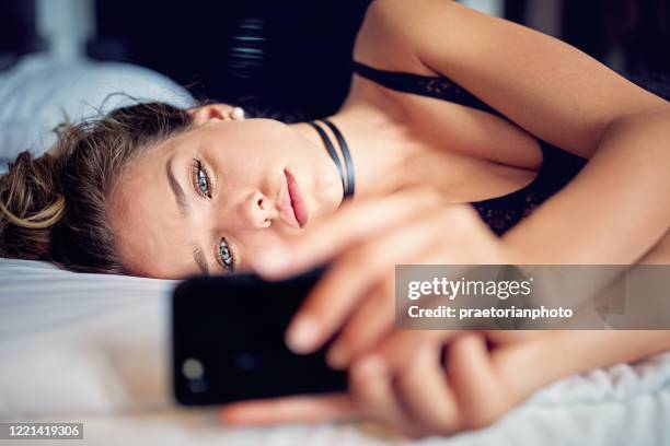 depressed young woman is lying in a bed - sexual issues stock pictures, royalty-free photos & images