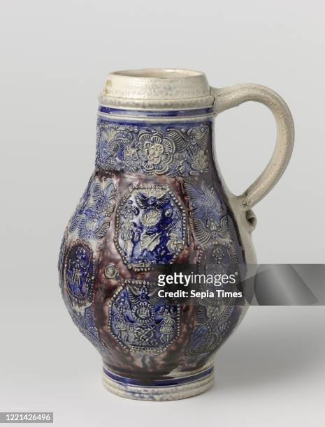 Jug with medallions, birds and flowers, Stoneware jug on stand ring with a pear-shaped body and wide neck. The C-shaped ear is attached to the neck...