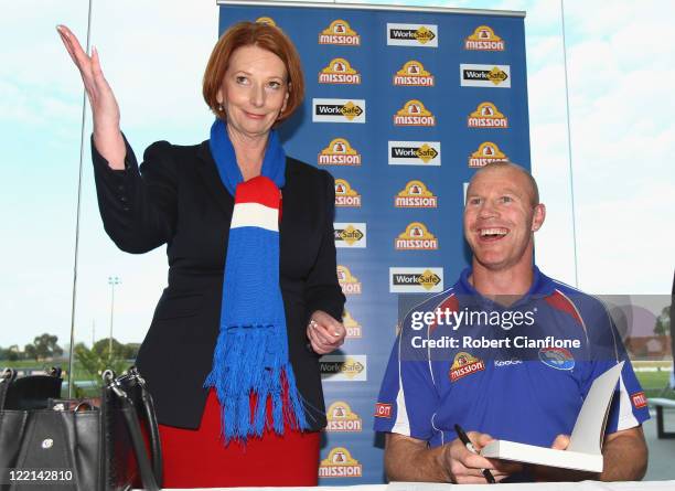 Prime Minister Julia Gillard is seen with Barry Hall at the official launch of his new book 'Pulling No Punches' at Whitten Oval on August 26, 2011...