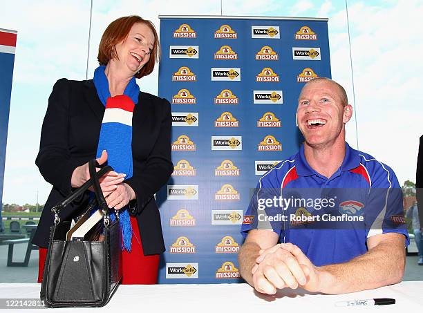 Prime Minister Julia Gillard is seen with Barry Hall at the official launch of his new book 'Pulling No Punches' at Whitten Oval on August 26, 2011...