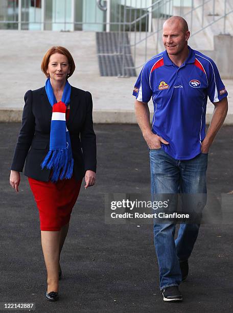 Prime Minister Julia Gillard arrives with Barry Hall for the official launch of Hall's new book 'Pulling No Punches' at Whitten Oval on August 26,...