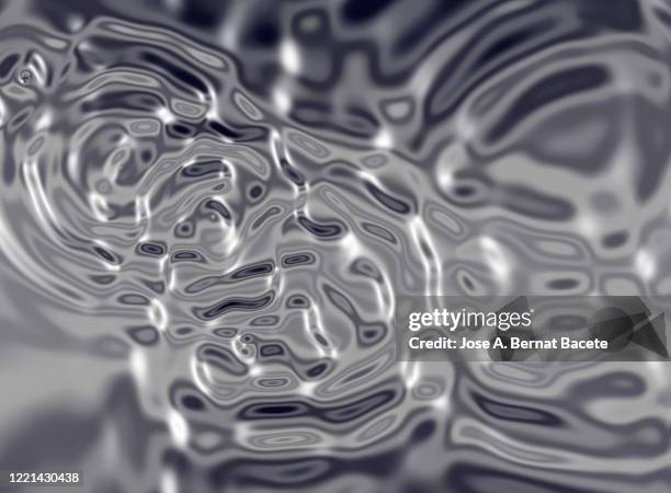 full frame of moving liquids on a gray background. - metallic liquid stock pictures, royalty-free photos & images