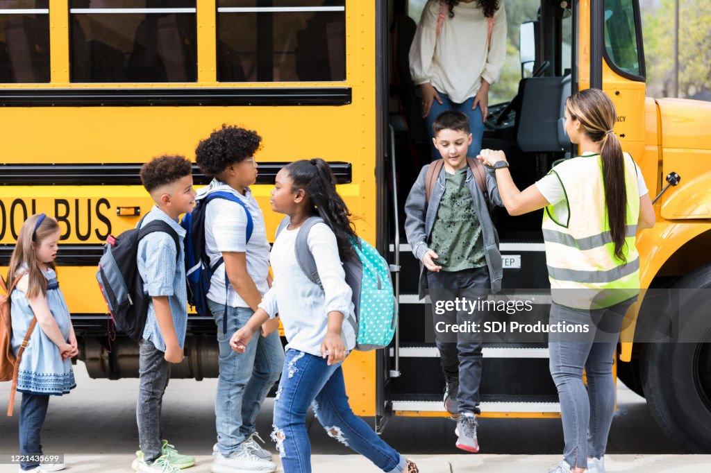 Bus driver helps children step off school bus