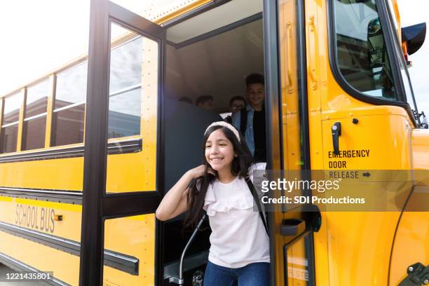 schoolgirl gets of off school bus - last day of school stock pictures, royalty-free photos & images
