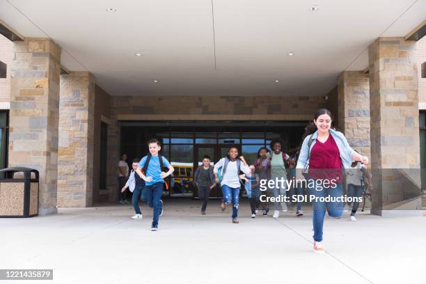 students run from school at the end of school year - last day of school stock pictures, royalty-free photos & images