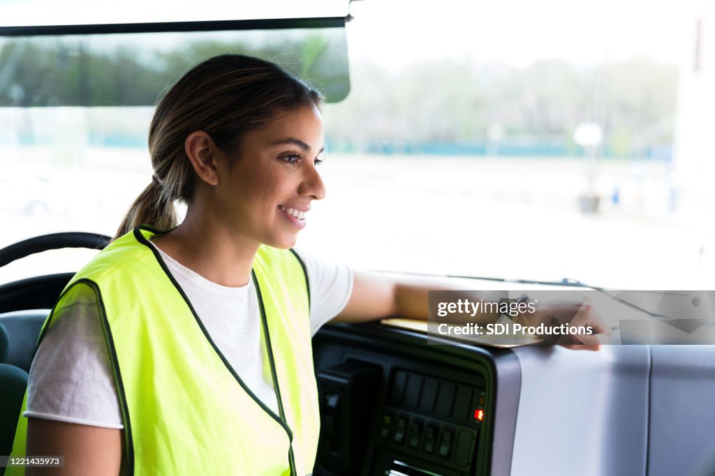 Female bus driver waits patiently for students during field trip