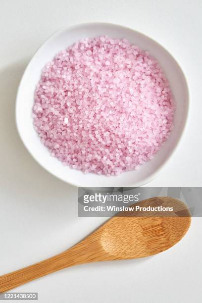 bath salt in bowl and wooden spoon - bath salt stock pictures, royalty-free photos & images