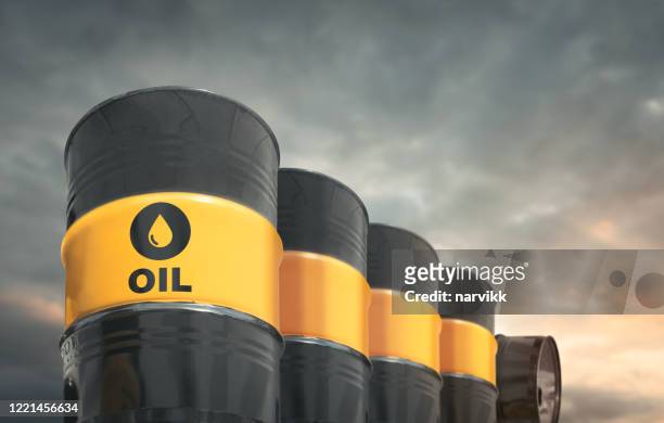 crude oil barrels in a row - crude oil stock pictures, royalty-free photos & images