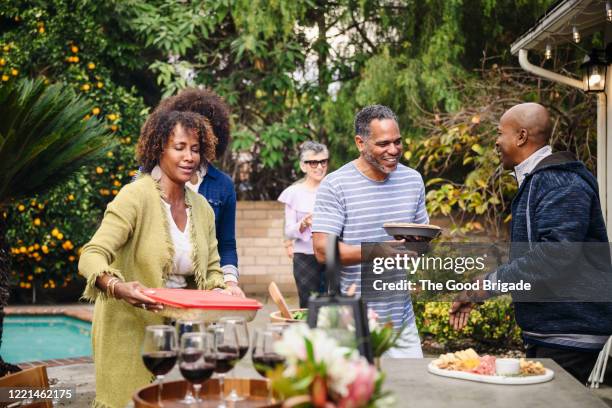 friends arrive for dinner party - the party arrivals stock pictures, royalty-free photos & images