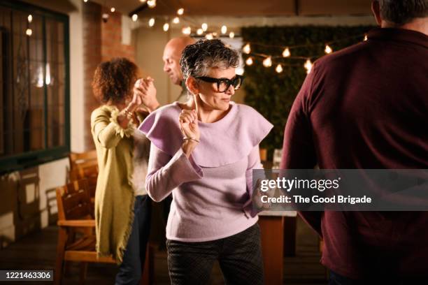 senior couple dancing at outdoor party - young at heart fotografías e imágenes de stock