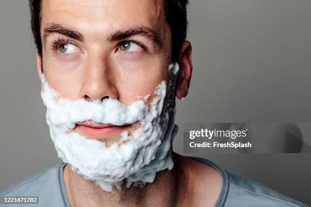 happy man with shaving foam on his face - shaving cream stock pictures, royalty-free photos & images