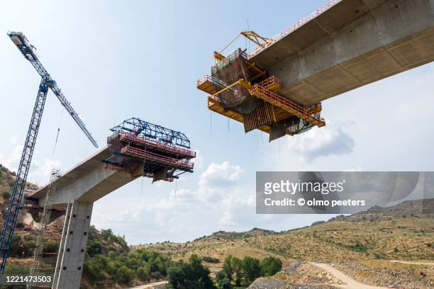 bridge construction over valley - bridge built structure stock pictures, royalty-free photos & images