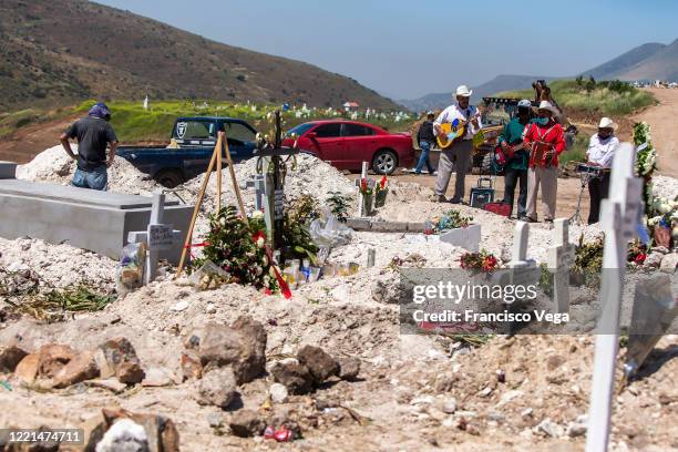 Musicians await for groups to offer their services during burials at Panteon número 13 on April 27, 2020 in Tijuana, Mexico. Baja California state...