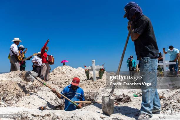 Cemetery workers dig a grave at Municipal cemetery Panteón número 13 on April 27, 2020 in Tijuana, Mexico. Baja California state remains as one of...