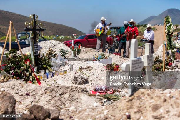 Musicians await for groups to offer their services during burials at Panteon número 13 on April 27, 2020 in Tijuana, Mexico. Baja California state...