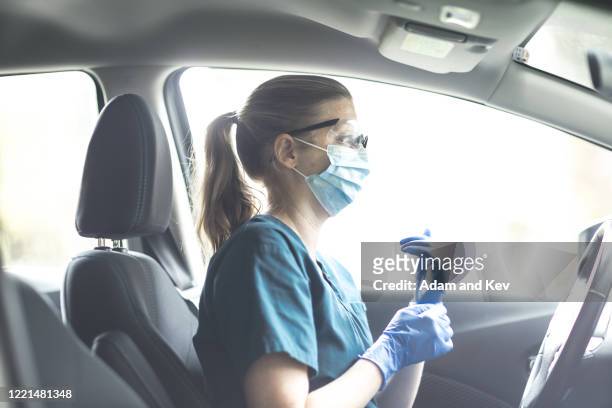 Community nurse getting ready in car.