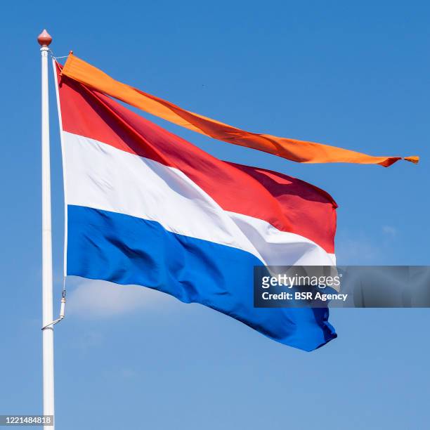 Dutch national flag with an orange banner is seen on King's Day amid the coronavirus outbreak on April 27, 2020 in Drachten, Netherlands. Due to the...