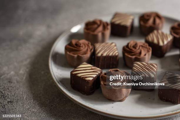 delicious chocolate candies on wooden background - praline stock pictures, royalty-free photos & images