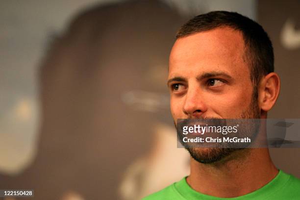 Sprinter Oscar Pistorius of South Africa speaks with Olympic gold medalist Michael Johnson of the United States during a media gathering at the...