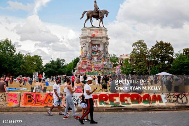 People gather around the Robert E. Lee statue on Monument Avenue in Richmond, Virginia on June 20, 2020. - The global civil unrest ignited by Floyd's...