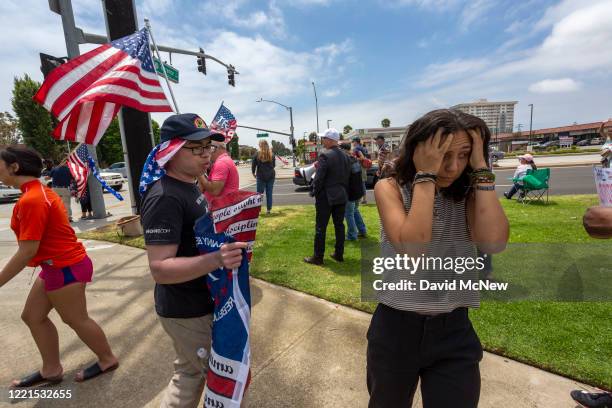 Woman turns away in frustration after arguing with a supporter of President Donald Trump at a pro-police rally as demonstrators across the nation...