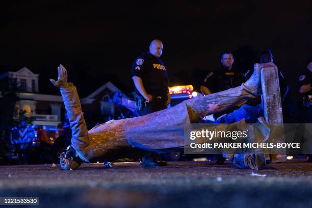 In this file photo a statue of Confederate States President Jefferson Davis lies on the street after protesters pulled it down in Richmond, Virginia,...