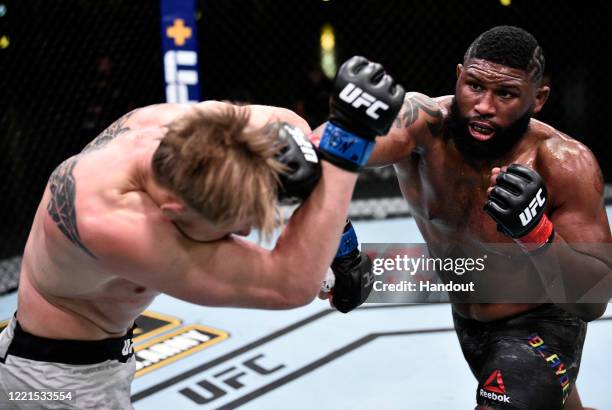 In this handout image provided by UFC, Curtis Blaydes punches Alexander Volkov of Russia in their heavyweight bout during the UFC Fight Night event...