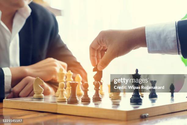 close up business hand play chess game to development analysis new strategy plan, leader and teamwork concept , - chess king piece stock pictures, royalty-free photos & images