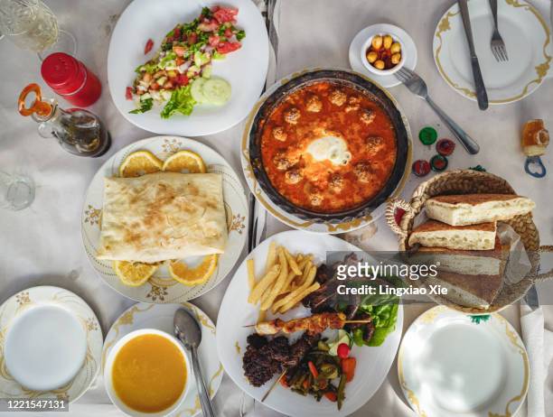 traditional moroccan food of famous kefta mkaouara tagine, shawarma wrap, grilled kebab and vegetable salad, morocco - tajine fotografías e imágenes de stock