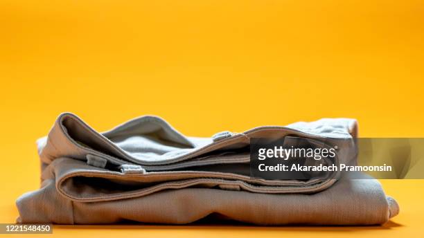 white pants placed on an orange background - white pants ストックフォトと画像