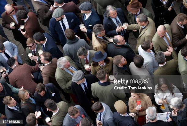 Racegoers socialising during day four of the Cheltenham National Hunt Racing Festival at Cheltenham Racecourse on March 13th 2020 in Gloucestershire