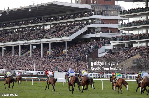 The finish of the first race in front of packed stands during day four of the Cheltenham National Hunt Racing Festival at Cheltenham Racecourse on...